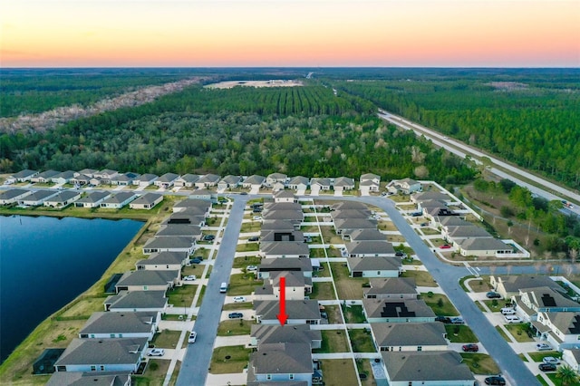 aerial view at dusk with a water view