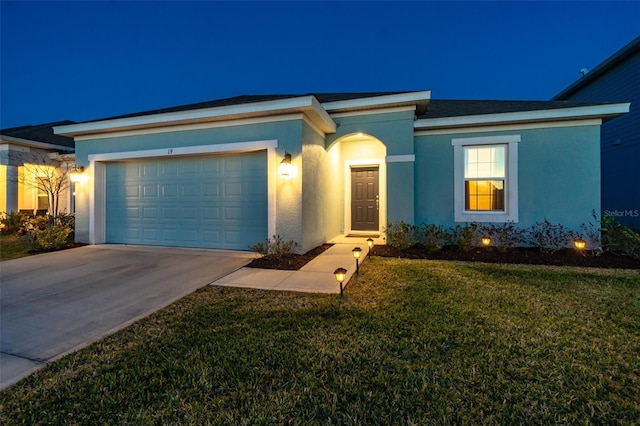 view of front of home with a front yard and a garage