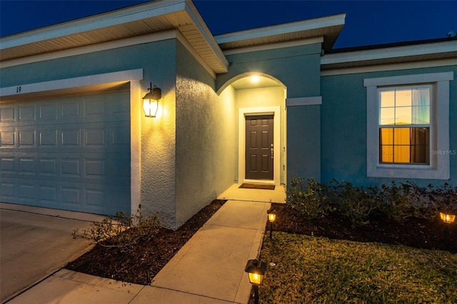 exterior entry at twilight with a garage