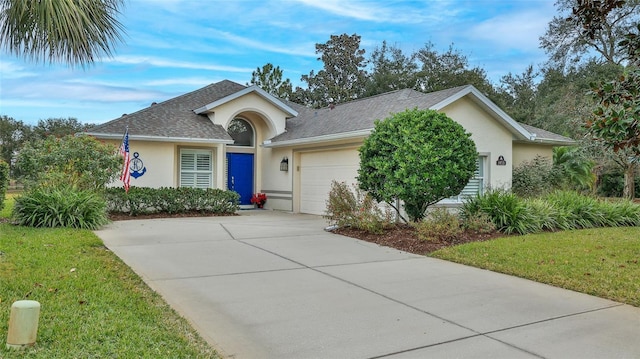 single story home with a front yard and a garage