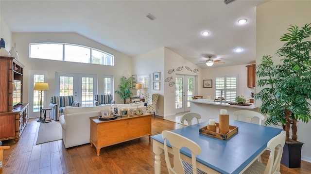 living room featuring ceiling fan, dark hardwood / wood-style flooring, french doors, and a healthy amount of sunlight