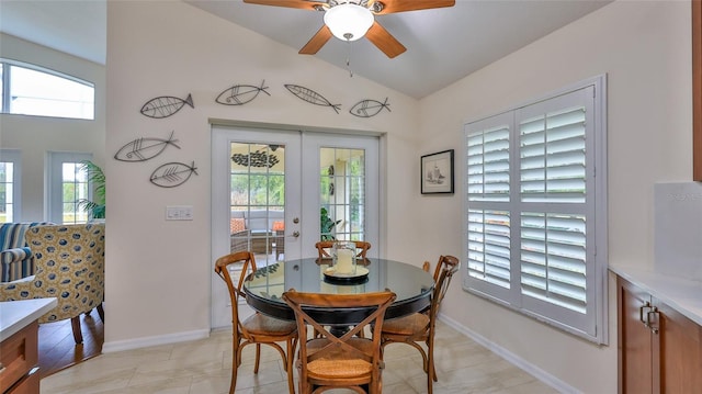 dining space featuring ceiling fan, french doors, and vaulted ceiling