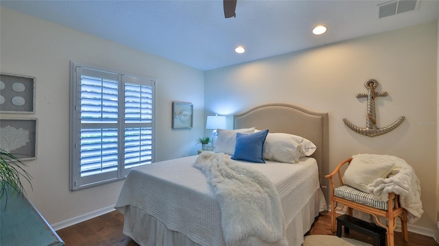 bedroom with ceiling fan and dark hardwood / wood-style flooring