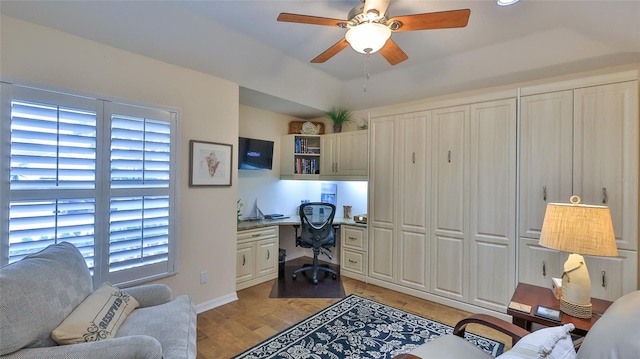 home office with light hardwood / wood-style floors, ceiling fan, and a healthy amount of sunlight