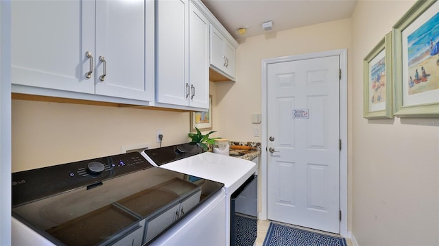 washroom with cabinets and separate washer and dryer