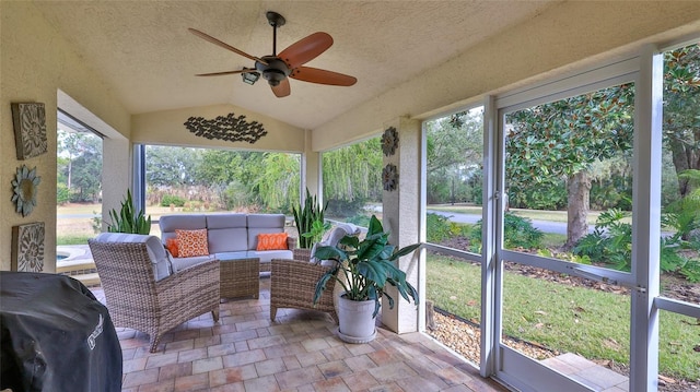 sunroom / solarium featuring vaulted ceiling, ceiling fan, and a wealth of natural light