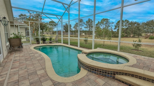 view of swimming pool with an in ground hot tub, a patio area, a yard, and glass enclosure