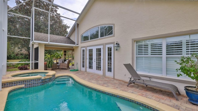 view of swimming pool with french doors, a lanai, an in ground hot tub, and a patio