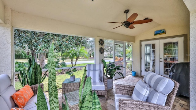 sunroom / solarium featuring ceiling fan, french doors, and vaulted ceiling