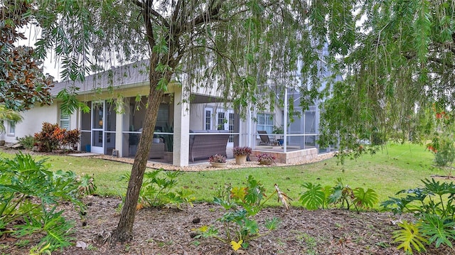 back of property featuring a lawn and a patio area