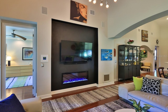 living room featuring ceiling fan and wood-type flooring