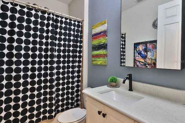 bathroom with toilet and vanity