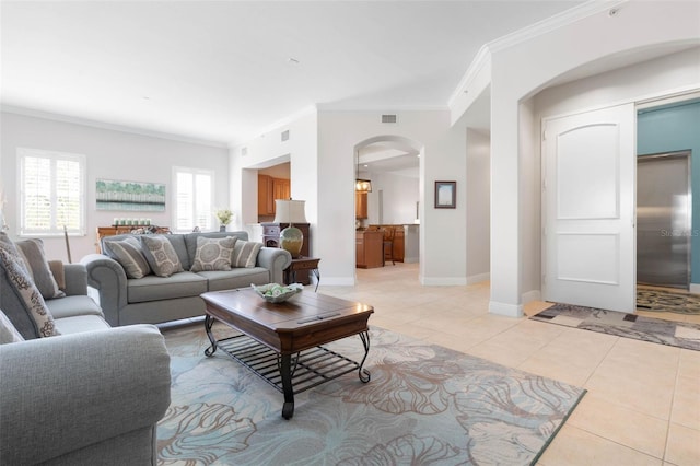 living room with light tile patterned floors and ornamental molding