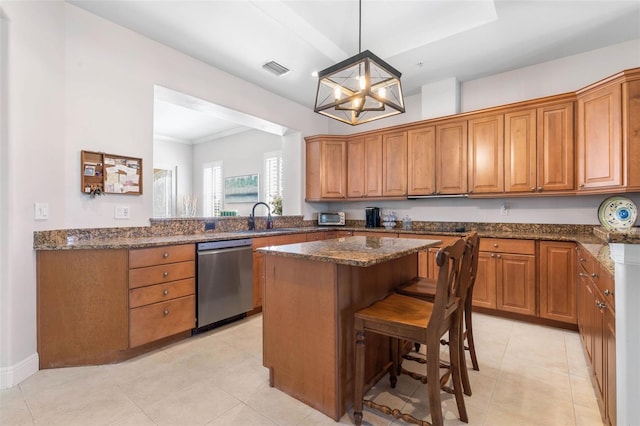 kitchen with hanging light fixtures, a kitchen island, dishwasher, and dark stone counters