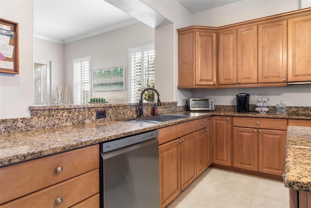 kitchen featuring light tile patterned floors, dark stone countertops, ornamental molding, stainless steel dishwasher, and sink