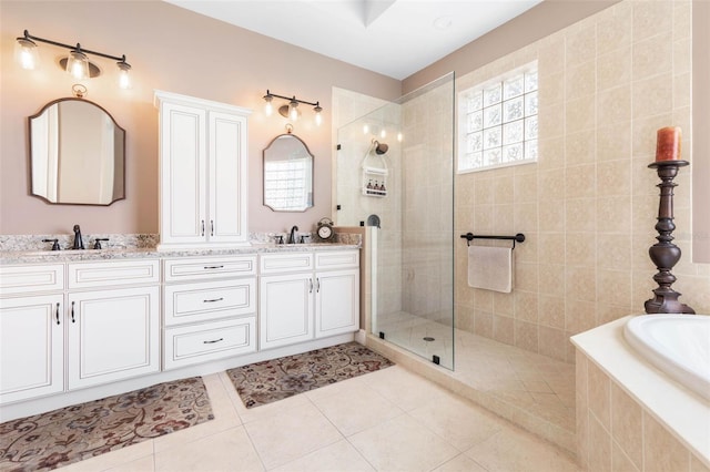 bathroom with independent shower and bath, tile patterned flooring, and vanity