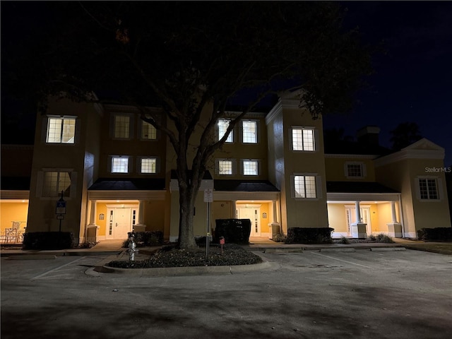 view of front of home with a garage and central air condition unit