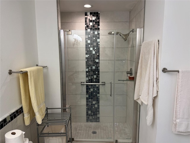 bathroom with tile walls and an enclosed shower