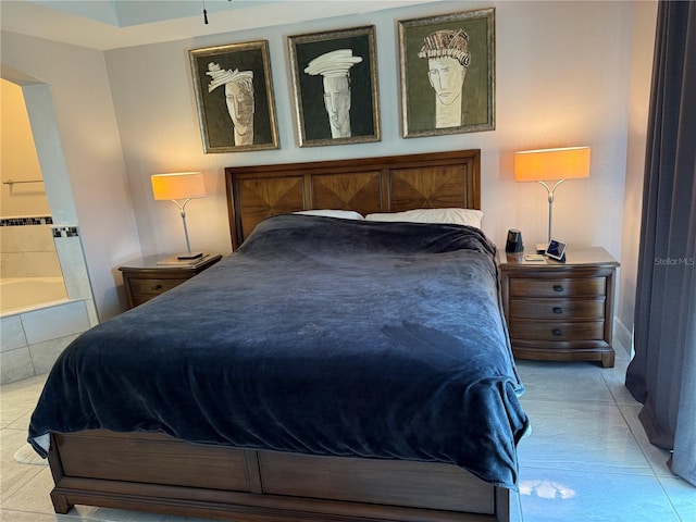 tiled bedroom featuring ensuite bath