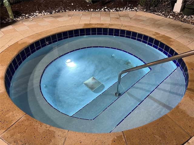 view of swimming pool featuring an in ground hot tub