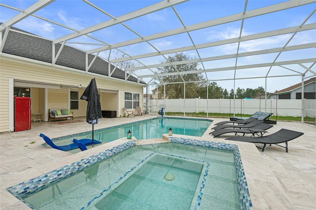 view of swimming pool featuring glass enclosure and a patio