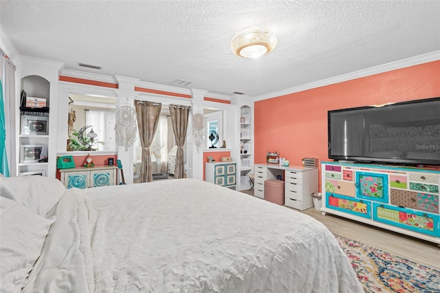 bedroom featuring crown molding, a textured ceiling, and hardwood / wood-style flooring