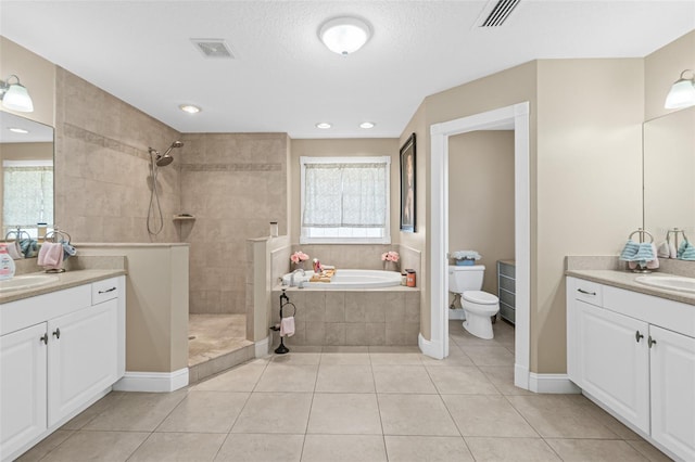 full bathroom with toilet, tile patterned flooring, and a healthy amount of sunlight