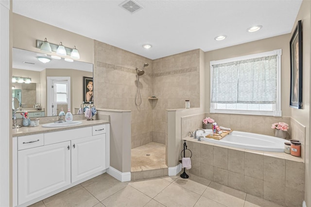 bathroom featuring a wealth of natural light, tile patterned floors, vanity, and independent shower and bath