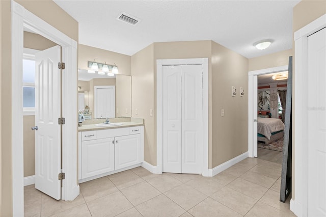 bathroom with vanity, tile patterned floors, and a textured ceiling