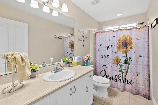 bathroom featuring toilet, tile patterned flooring, vanity, and curtained shower