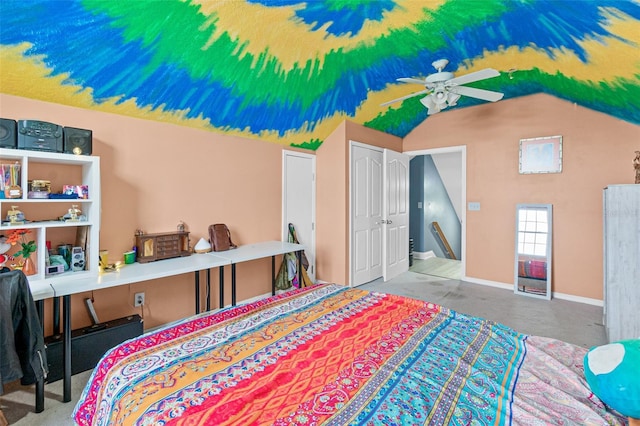 carpeted bedroom with ceiling fan, a closet, and vaulted ceiling