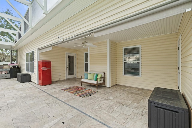 view of patio / terrace featuring ceiling fan and a lanai