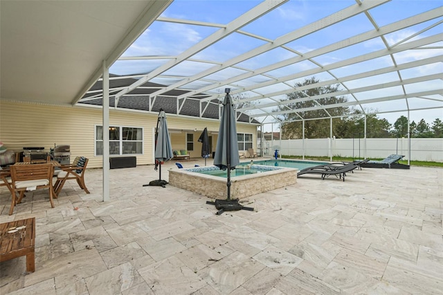 view of patio / terrace featuring glass enclosure and a swimming pool with hot tub