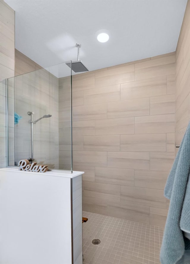 bathroom with a tile shower