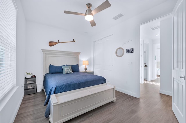 bedroom with hardwood / wood-style flooring, ceiling fan, and a closet