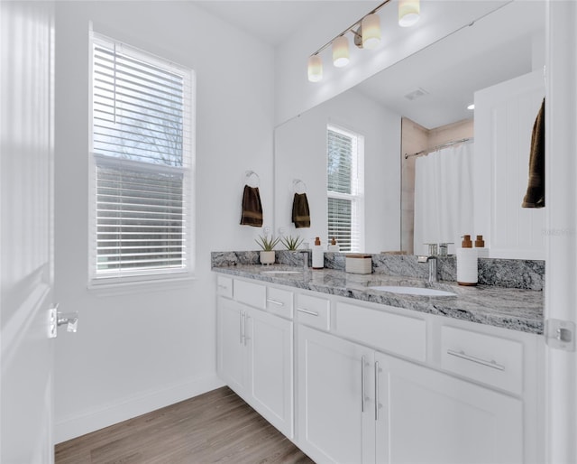 bathroom featuring a shower with curtain, vanity, and wood-type flooring