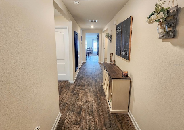 corridor featuring dark wood-type flooring