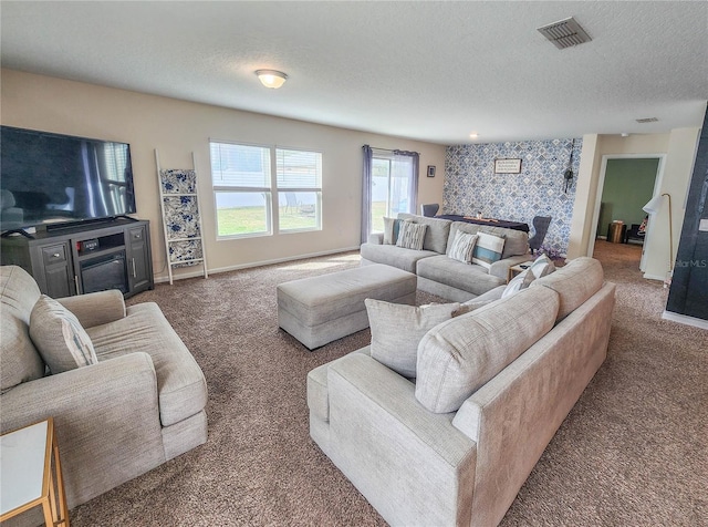 living room featuring a textured ceiling and dark colored carpet