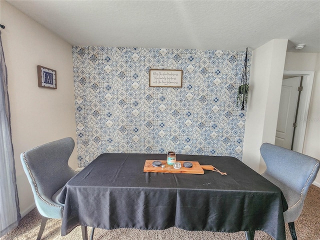 dining space with carpet floors and a textured ceiling