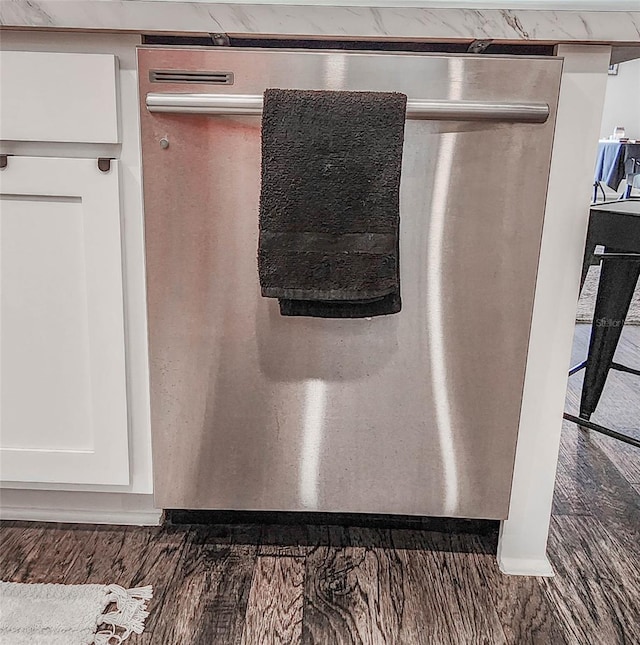 interior details with white cabinetry and stainless steel dishwasher