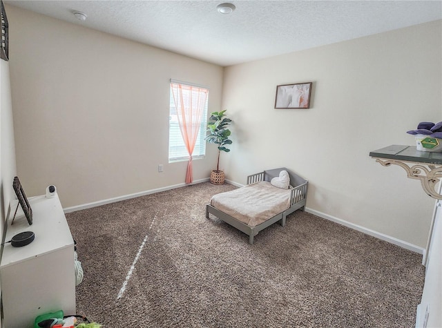 living area featuring dark carpet and a textured ceiling