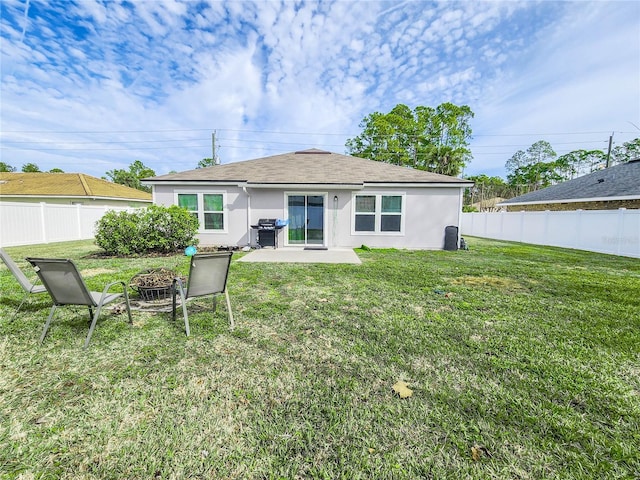 back of house featuring a patio area and a yard