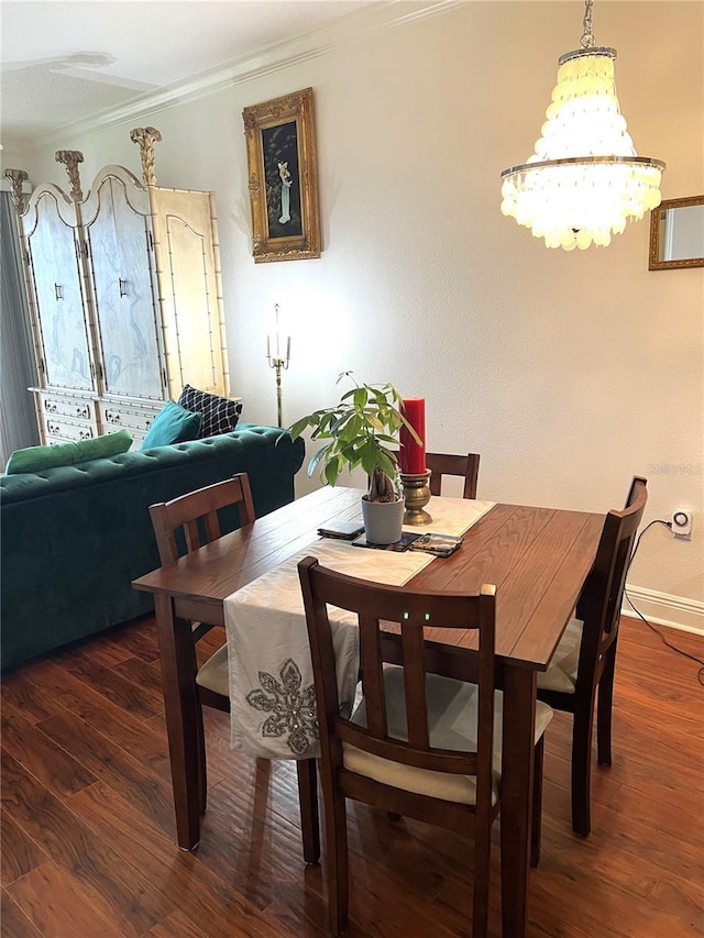 dining space with ornamental molding and dark wood-type flooring