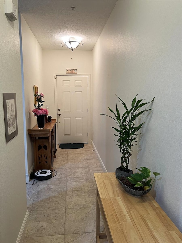 entryway featuring a textured ceiling