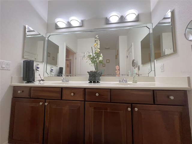 full bath with a sink and double vanity