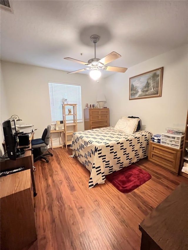 bedroom featuring hardwood / wood-style floors and ceiling fan