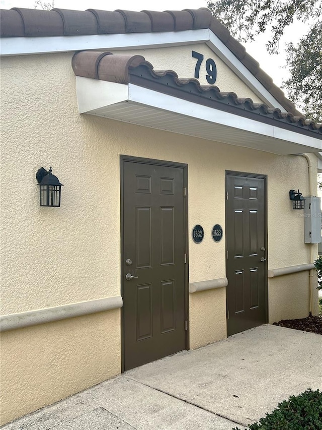 doorway to property with stucco siding