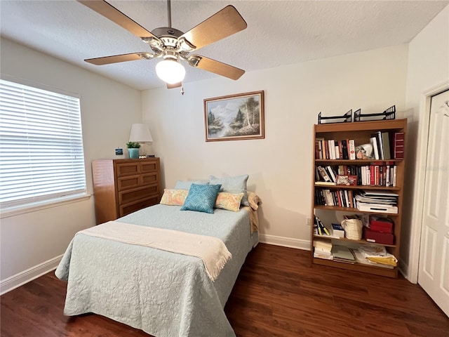 bedroom featuring a textured ceiling, ceiling fan, wood finished floors, and baseboards