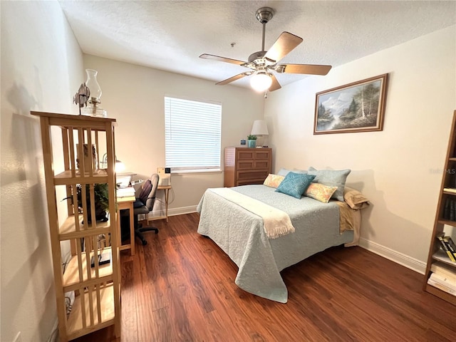 bedroom featuring a textured ceiling, wood finished floors, and baseboards