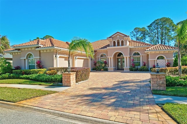 mediterranean / spanish home featuring a garage